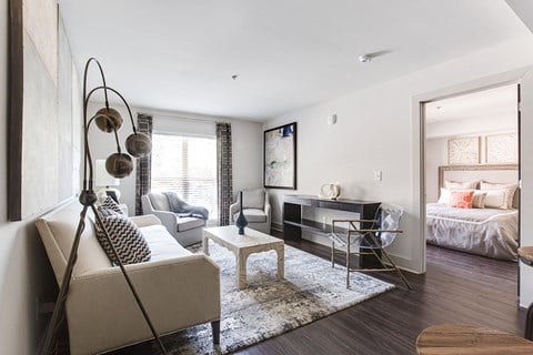 a living room with a couch and a chair and a television